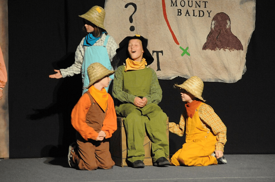 Young performers in costume on stage
